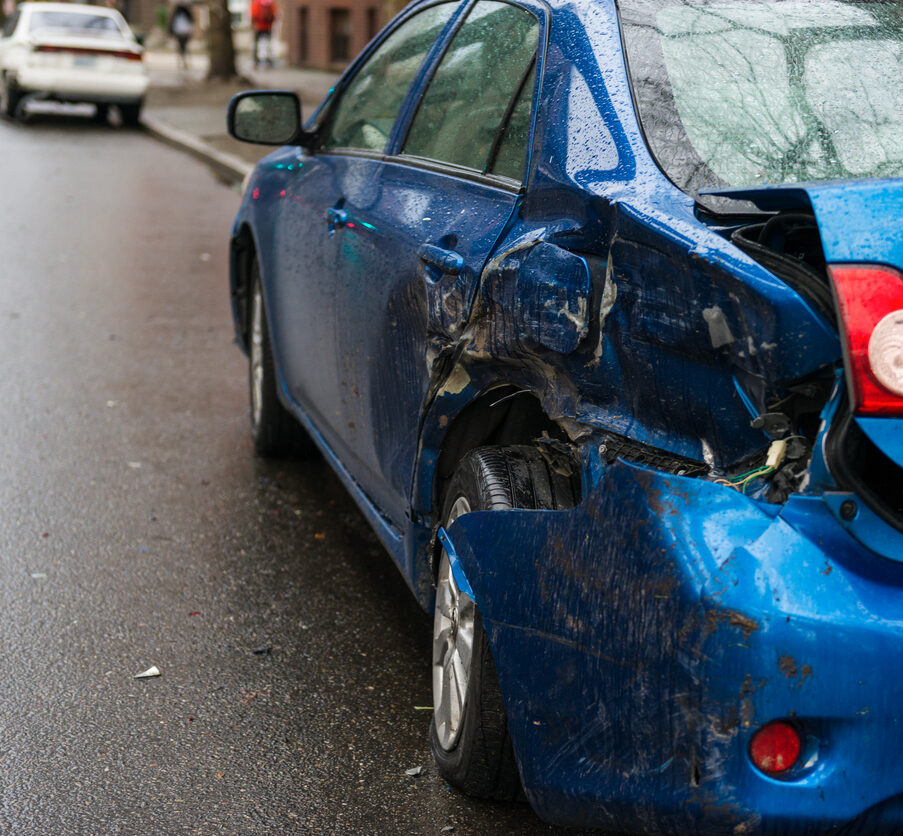 Hit and run involving a parked car on a city street.