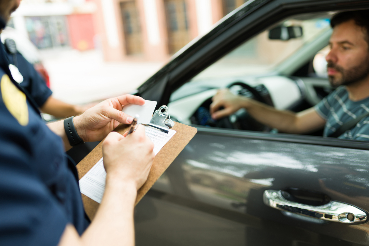 Police agent making a speeding ticket for a driver